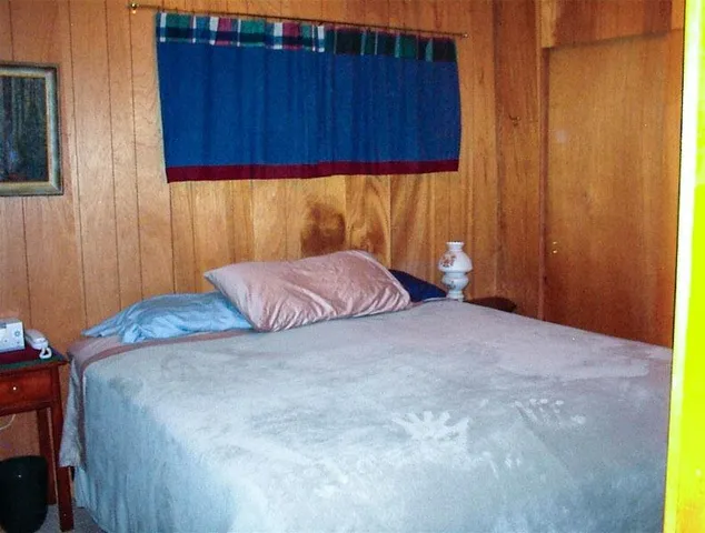 a bedroom with a bed and cabinets