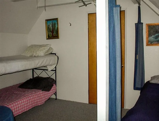 a bedroom with a bed and a table in it