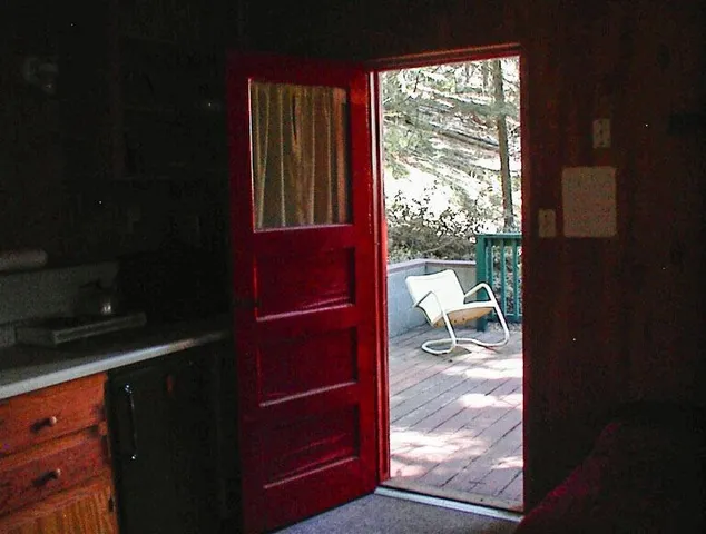 a living room with furniture a bed and a window
