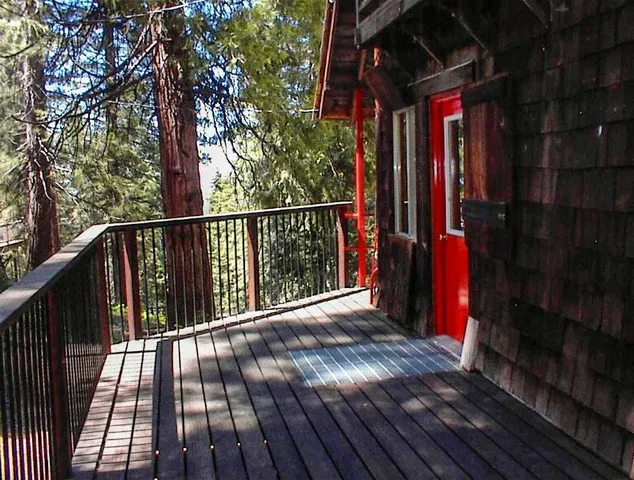 a view of balcony with wooden floor and fence