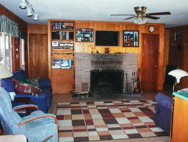 a living room with a flat screen tv and a fireplace