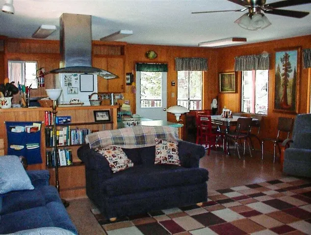 a living room with furniture fireplace and a large window