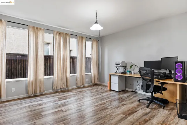 a workspace with furniture hardwood and a window