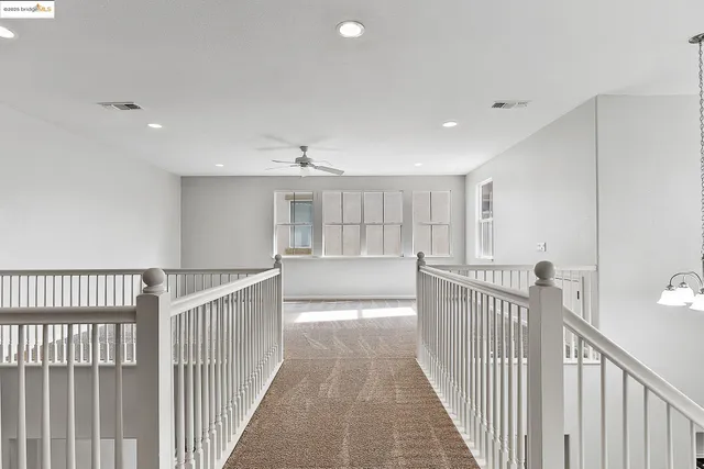 a view of a hallway with chandelier