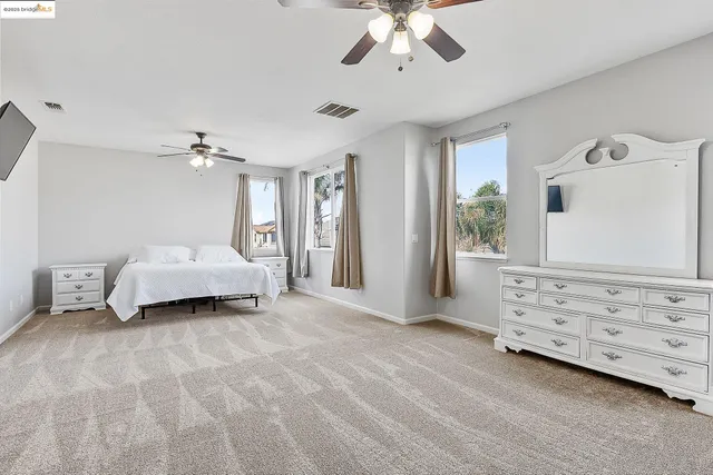 a bedroom with a bed and a chair