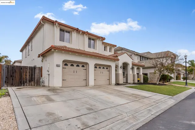a view of staircase with lots of frames on wall and wooden floor