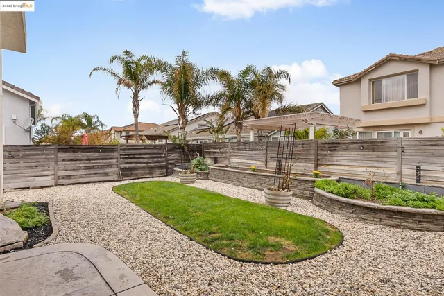 a view of a white house with a yard