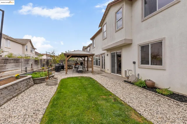 a view of a white house with garden