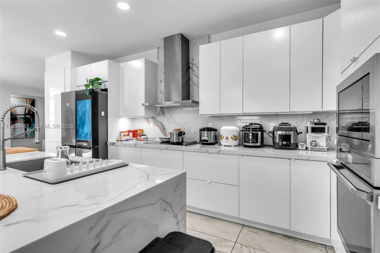 21380 Southwest 127th Place Miami, FL 33177 - Photo 14 of 47 a kitchen with cabinets appliances and a counter top space