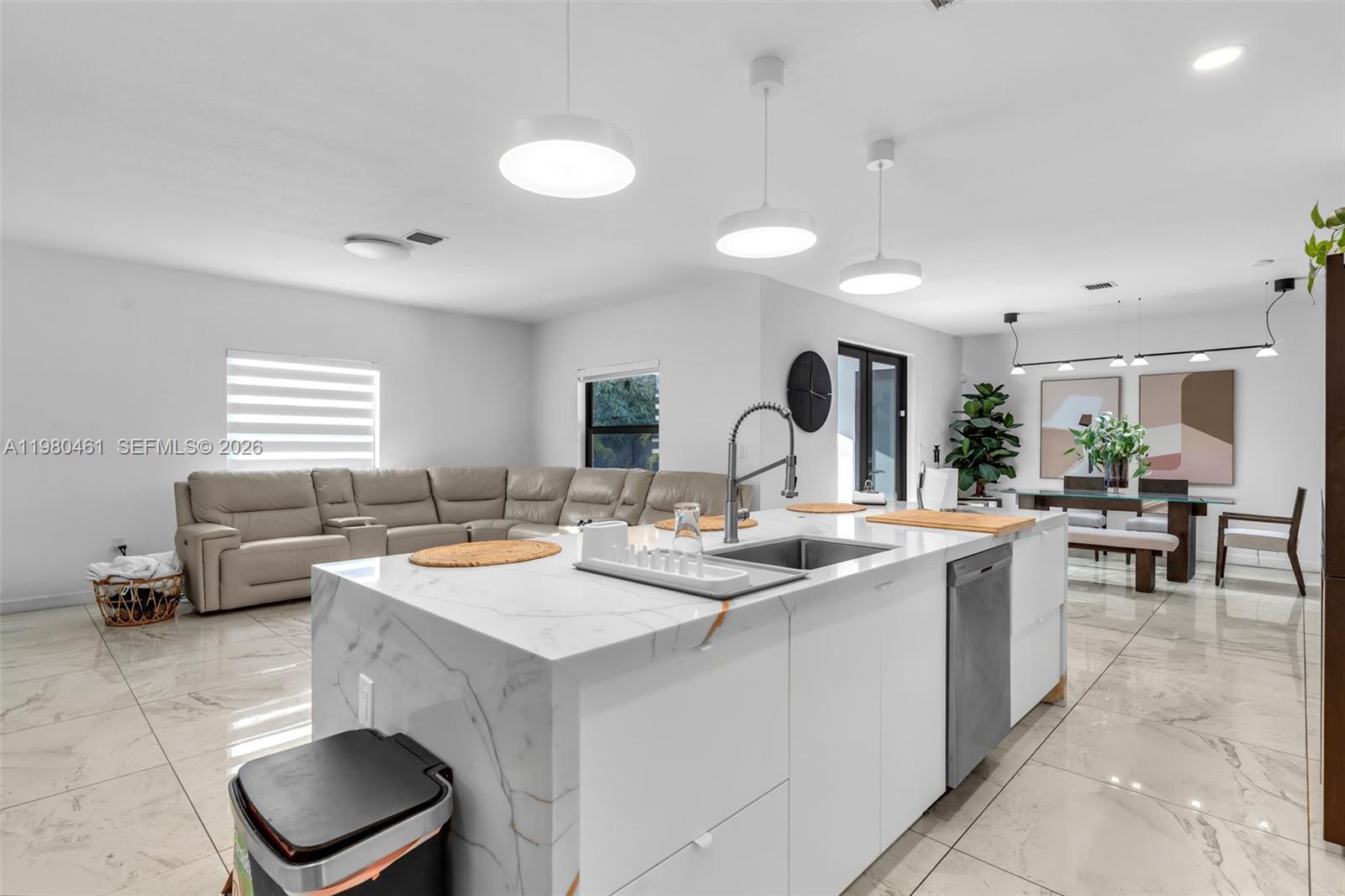 21380 Southwest 127th Place Miami, FL 33177 - Photo 15 of 47 a open kitchen with stainless steel appliances granite countertop a sink a stove and a dining table with garden view