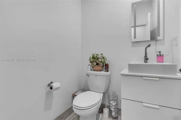 a white toilet sitting next to a bathroom sink