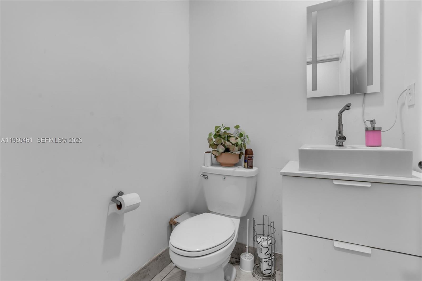 21380 Southwest 127th Place Miami, FL 33177 - Photo 16 of 47 a white toilet sitting next to a bathroom sink