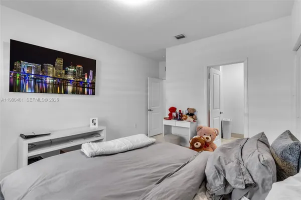 a bedroom with a bed and a bookshelf