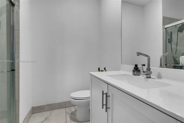 a bathroom with a sink toilet and mirror