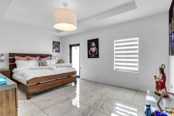 a spacious bedroom with a bed and a window