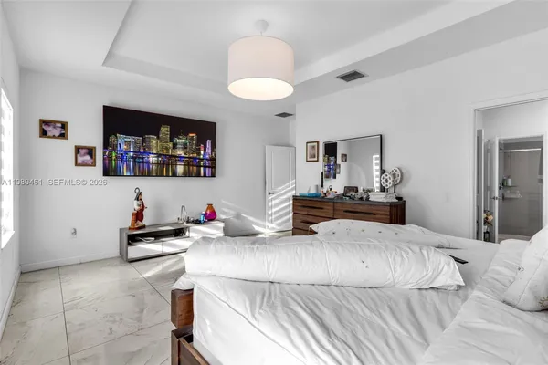 a bedroom with furniture and a flat screen tv