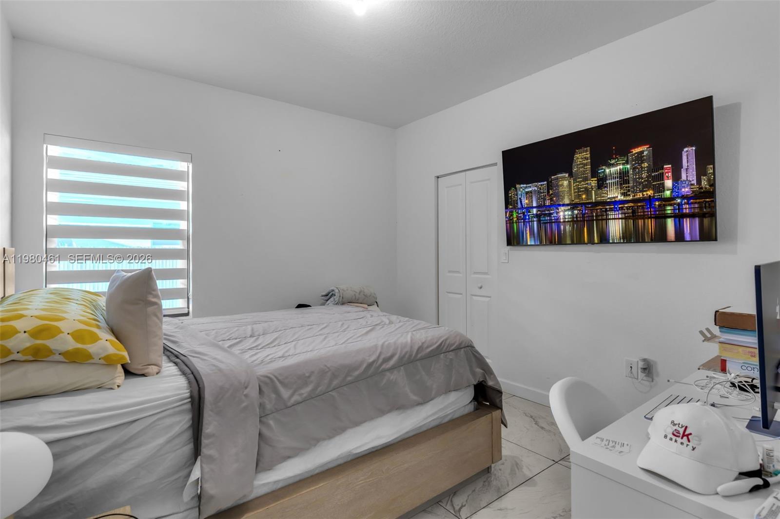 21380 Southwest 127th Place Miami, FL 33177 - Photo 28 of 47 a bedroom with a bed and a flat screen tv