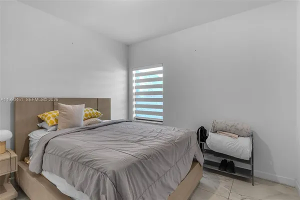 a bedroom with a bed and window