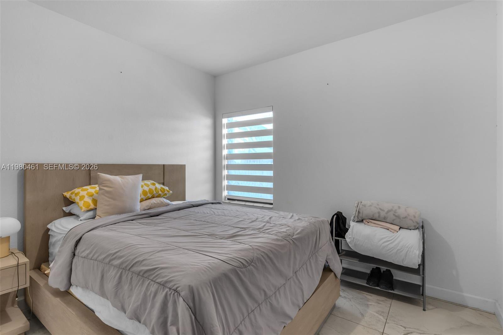 21380 Southwest 127th Place Miami, FL 33177 - Photo 29 of 47 a bedroom with a bed and window