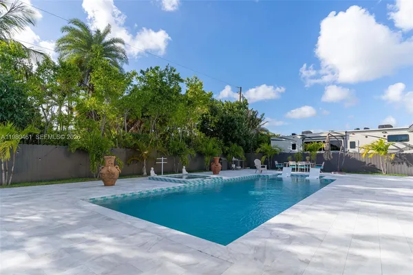 a view of a backyard with sitting area
