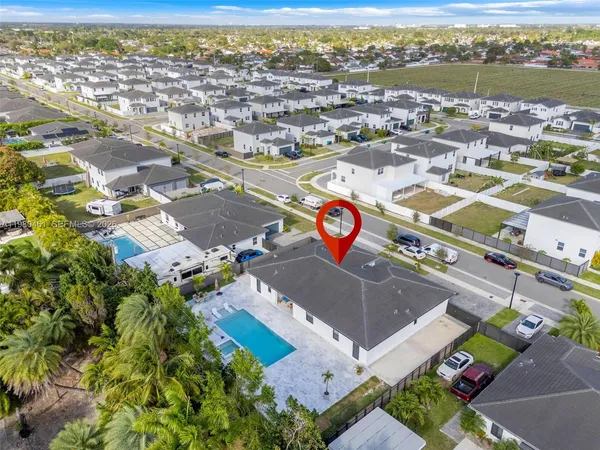 an aerial view of residential houses with outdoor space