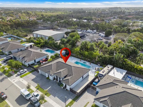 an aerial view of a house with a yard