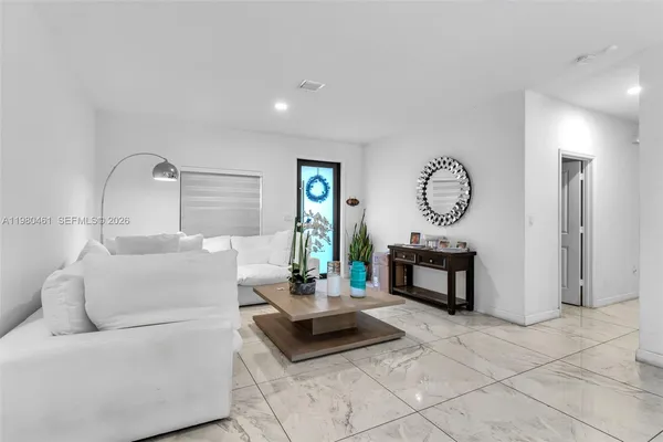 a living room with furniture a clock and a window