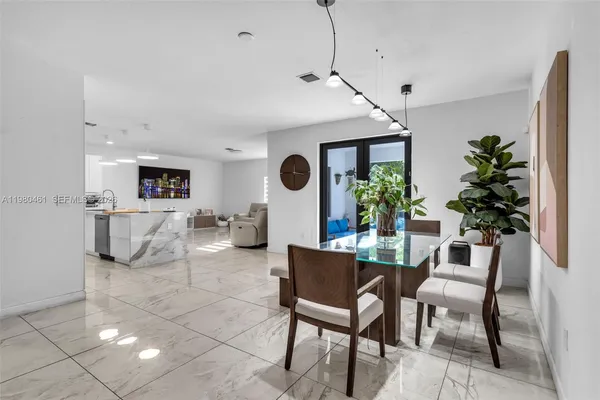 a dining room with furniture and a large window