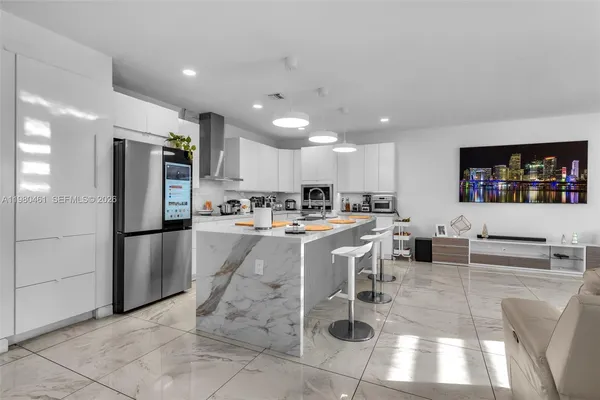 a view of kitchen with stainless steel appliances kitchen island microwave and cabinets