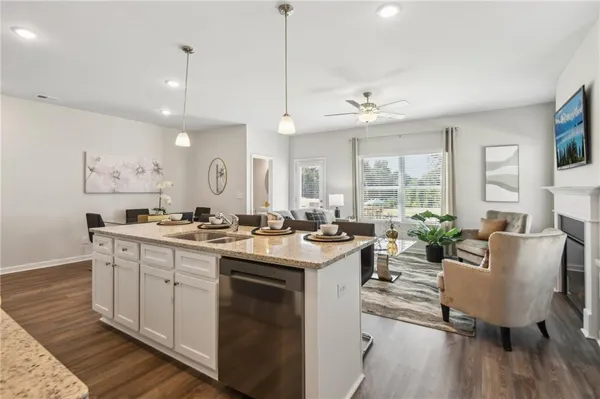 a open kitchen with stainless steel appliances granite countertop a sink stove and wooden floor