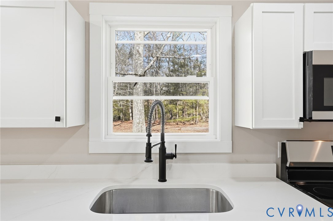 286 Mill Pond Road South St. Stephens Church, VA 23148 - Photo 11 of 39 a kitchen with granite countertop a sink and a window