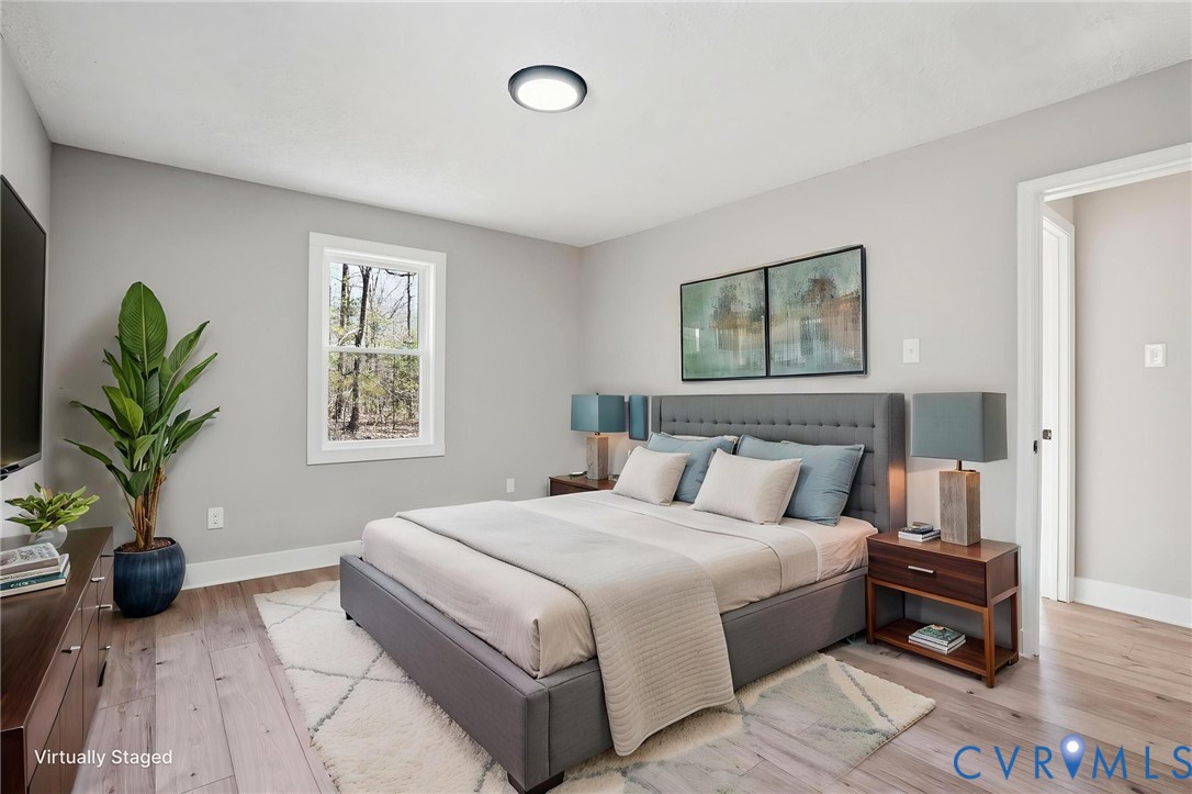286 Mill Pond Road South St. Stephens Church, VA 23148 - Photo 16 of 39 a bedroom with a bed a couch and a potted plant