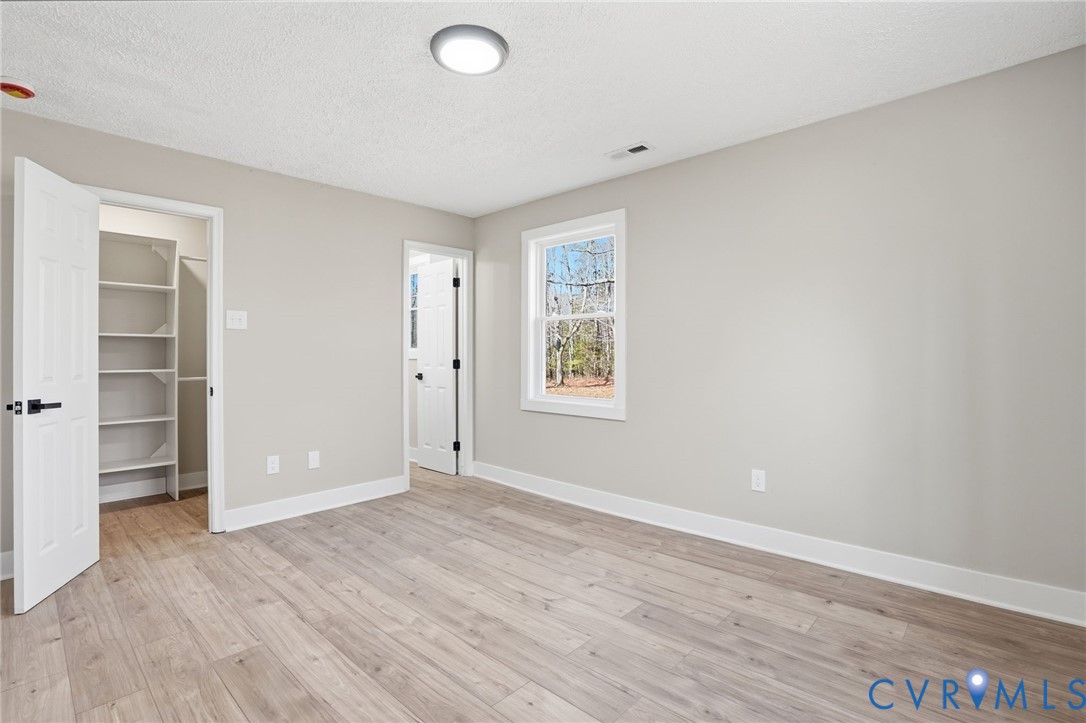 286 Mill Pond Road South St. Stephens Church, VA 23148 - Photo 22 of 39 an empty room with closet and windows