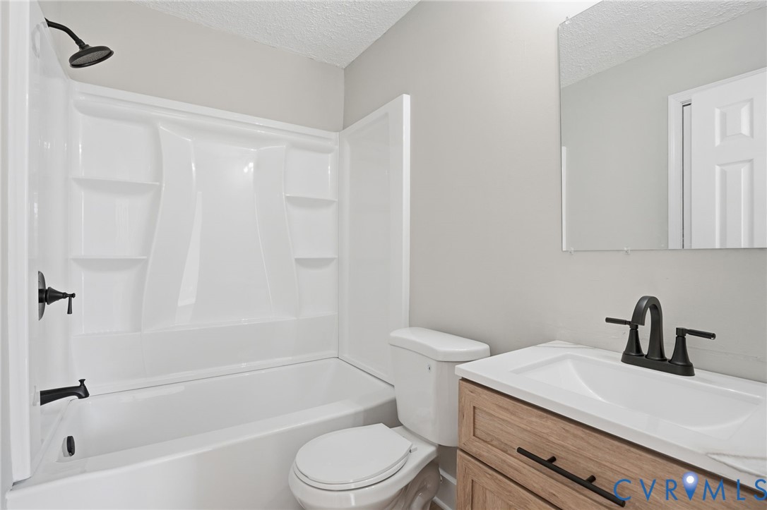 286 Mill Pond Road South St. Stephens Church, VA 23148 - Photo 23 of 39 a bathroom with a sink a toilet and a bathtub