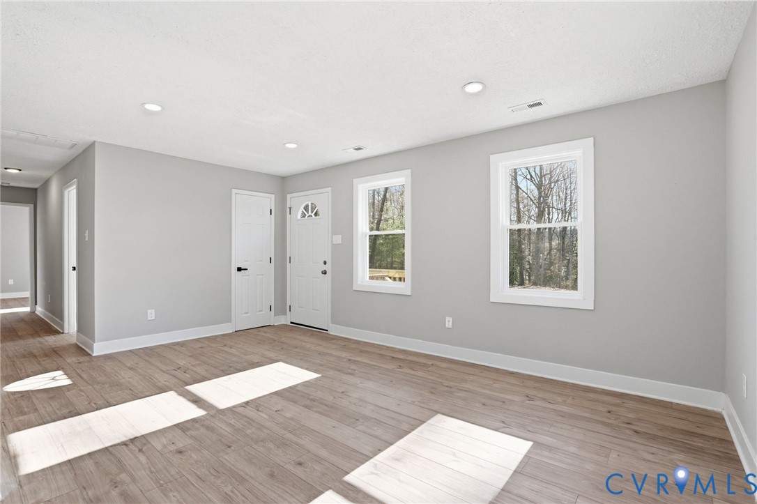 286 Mill Pond Road South St. Stephens Church, VA 23148 - Photo 4 of 39 a view of an empty room with wooden floor and a window