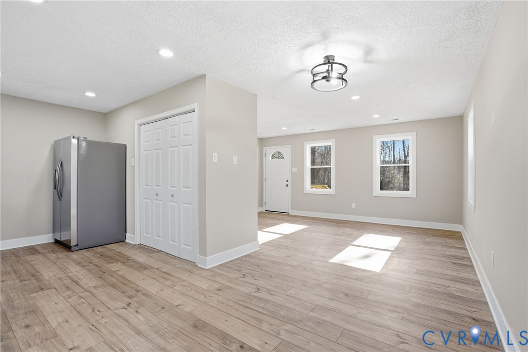 286 Mill Pond Road South St. Stephens Church, VA 23148 - Photo 7 of 39 a view of an empty room with wooden floor and a window
