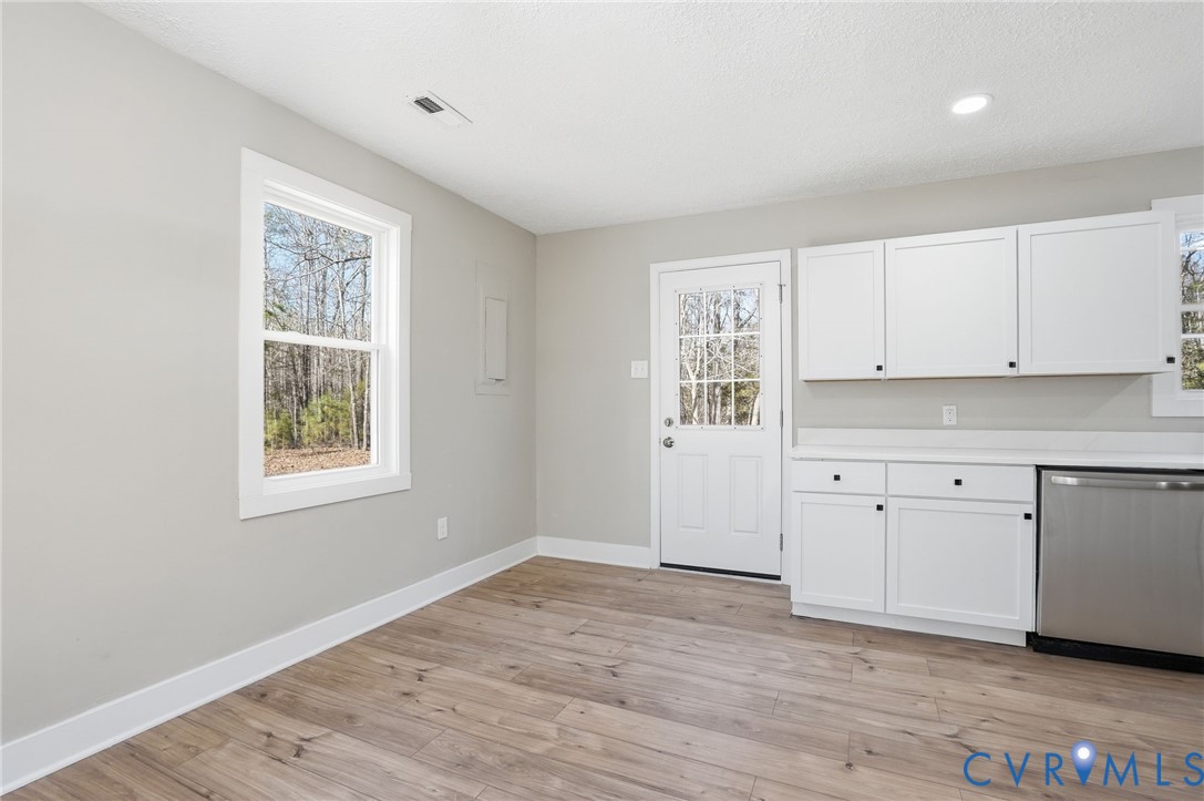 286 Mill Pond Road South St. Stephens Church, VA 23148 - Photo 8 of 39 a view of a kitchen with wooden floor and windows