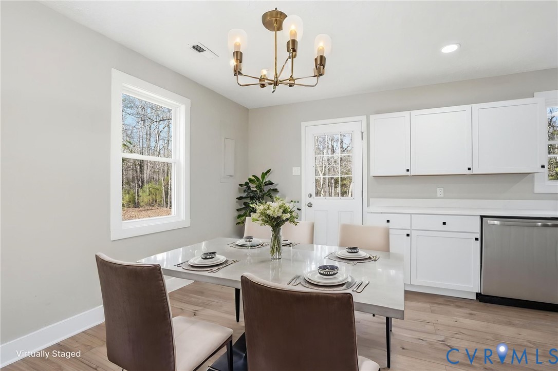 286 Mill Pond Road South St. Stephens Church, VA 23148 - Photo 9 of 39 a view of a dining room with furniture window and wooden floor