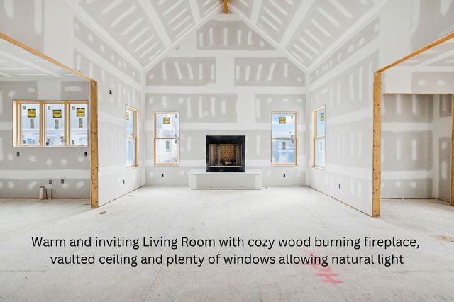 a view of an empty room with a fireplace and a window