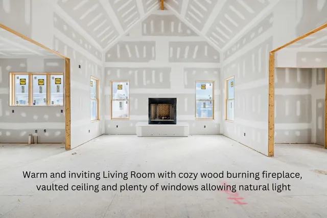 a view of an empty room with a fireplace and a window