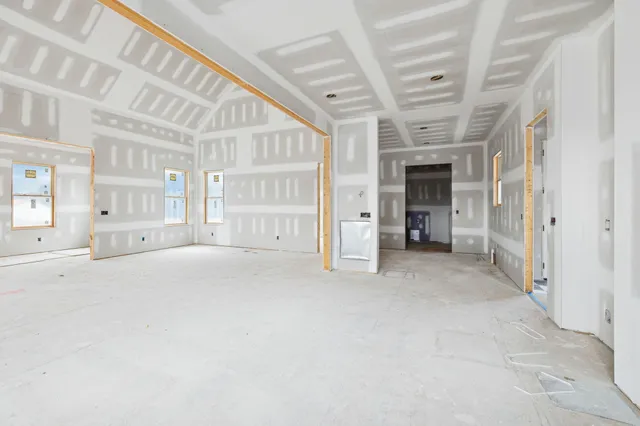 a view of a hallway with entryway and chandelier