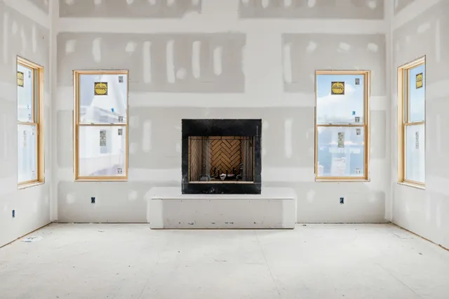 a large white bed sitting in a spacious bedroom