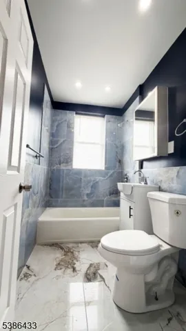 a city street lined with parked cars and buildings