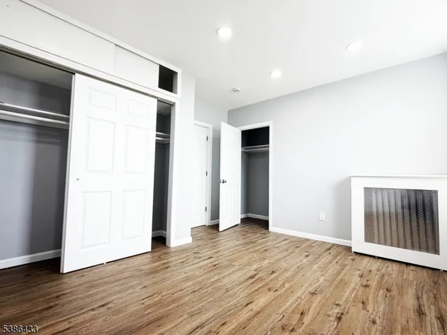 a view of a room with wooden floor and windows