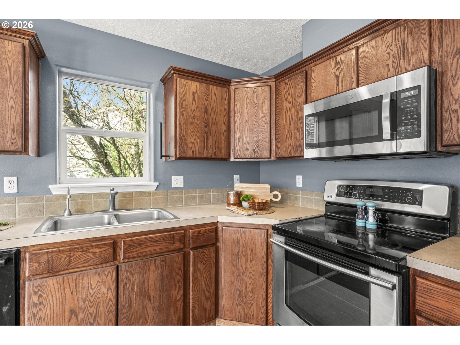 38882 Haskins Street Sandy, OR 97055 - Photo 18 of 46 a kitchen with stainless steel appliances granite countertop a sink stove and microwave