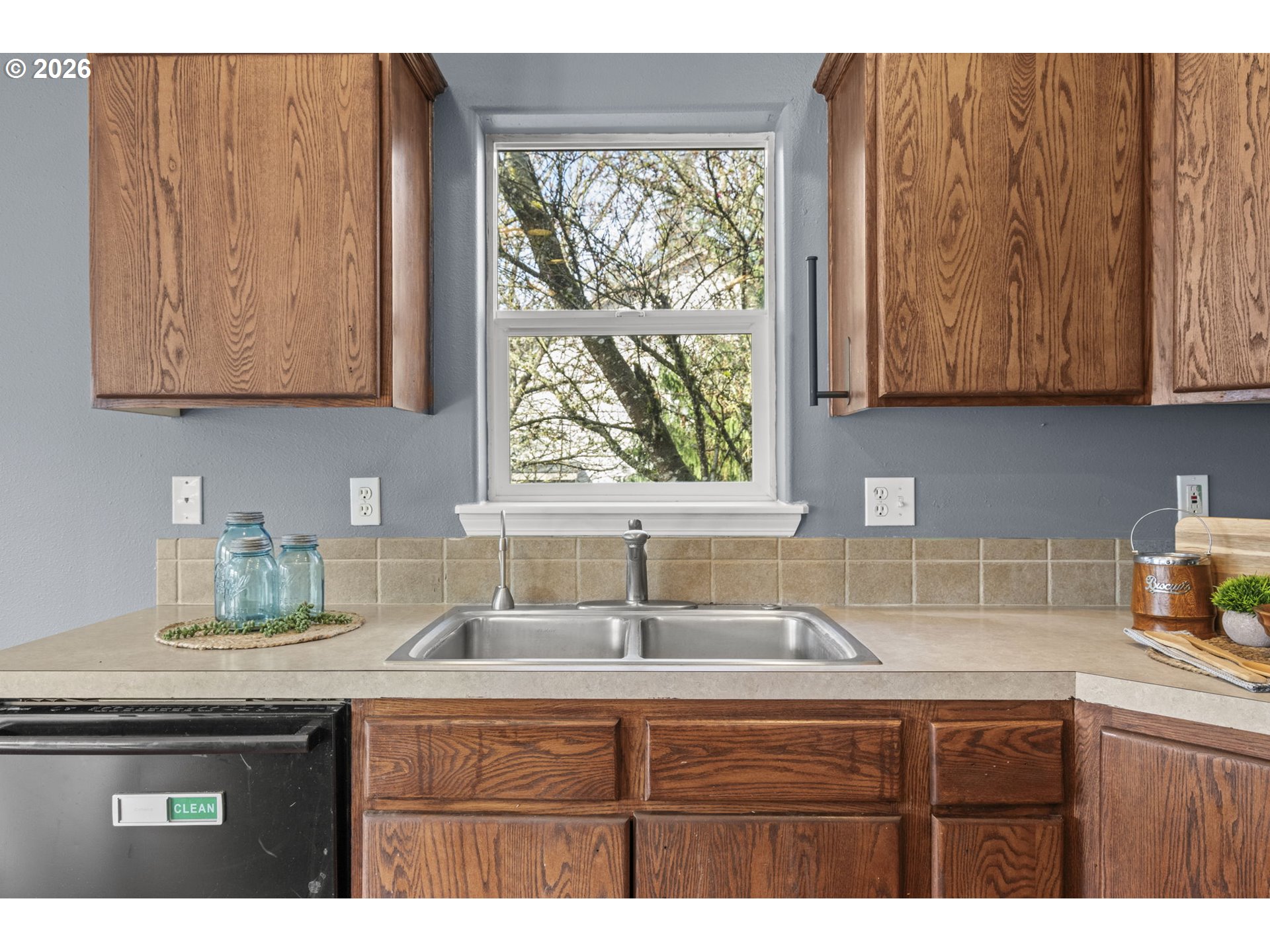 38882 Haskins Street Sandy, OR 97055 - Photo 19 of 46 a kitchen with granite countertop a sink a window and cabinets