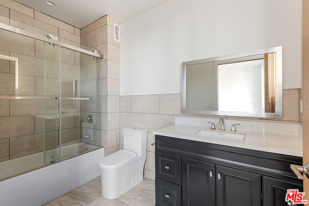 1429 South Bedford Street, Unit 201 Los Angeles, CA 90035 - Photo 12 of 12 a bathroom with a sink a toilet and shower