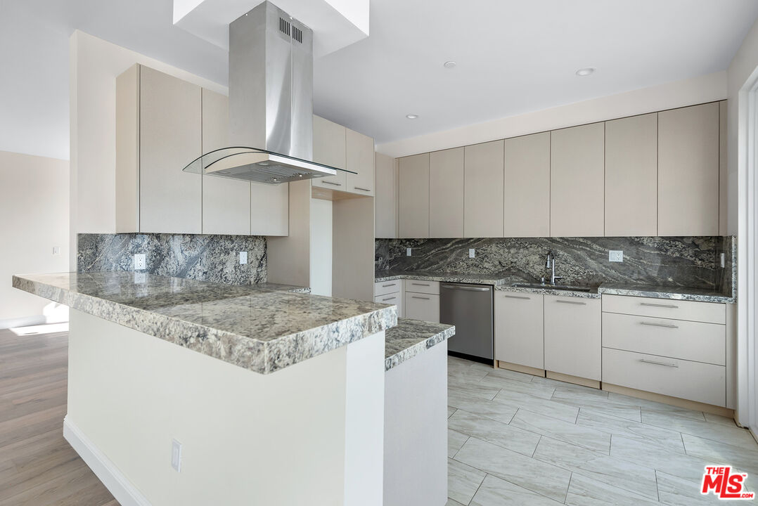 1429 South Bedford Street, Unit 201 Los Angeles, CA 90035 - Photo 2 of 12 a kitchen with stainless steel appliances granite countertop a sink stove and cabinets