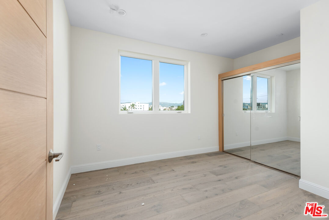 1429 South Bedford Street, Unit 201 Los Angeles, CA 90035 - Photo 8 of 12 an empty room with windows