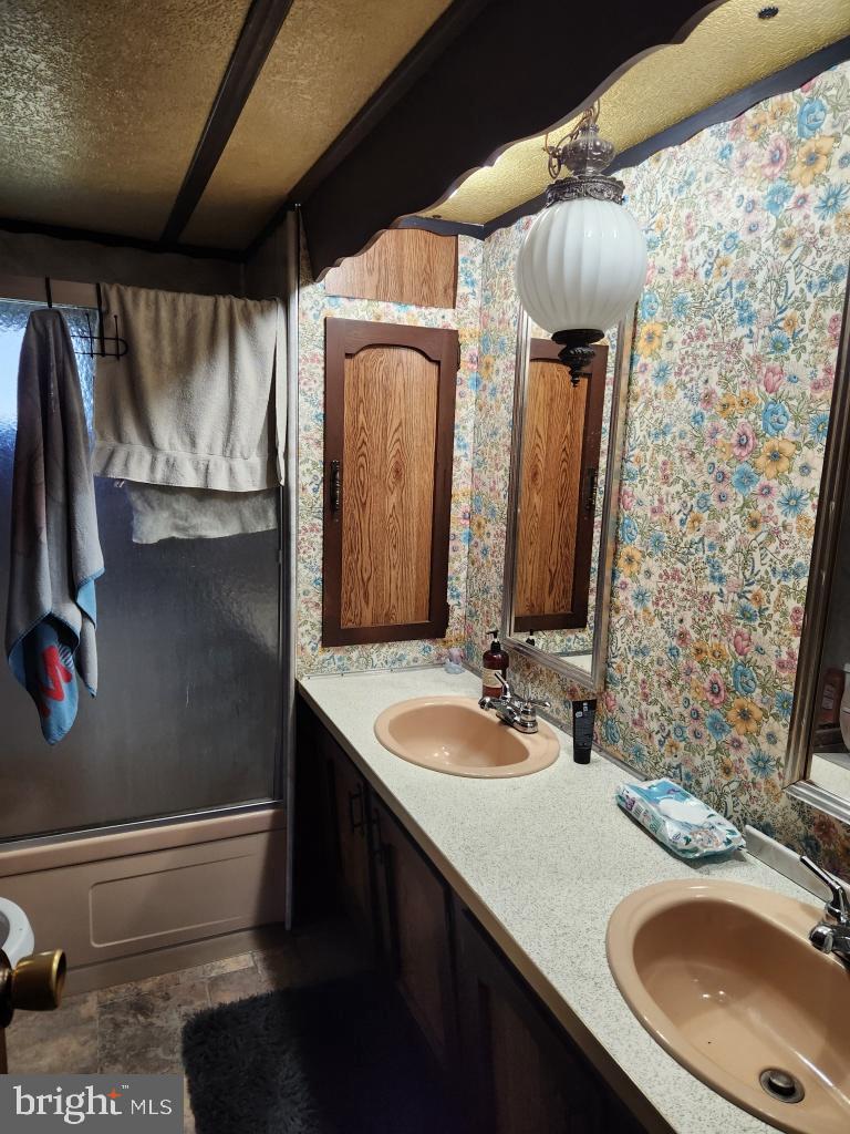 1692 Gish Road Manheim, PA 17545 - Photo 14 of 35 a bathroom with a granite countertop sink a mirror and shower